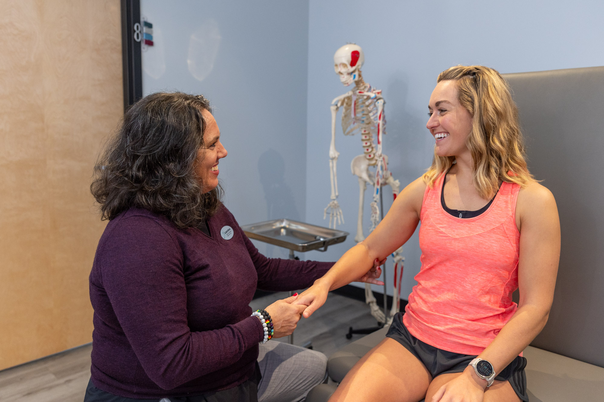 Female patient receiving treatment from her medical provider in a treatment room after getting dry needling in Chicago.