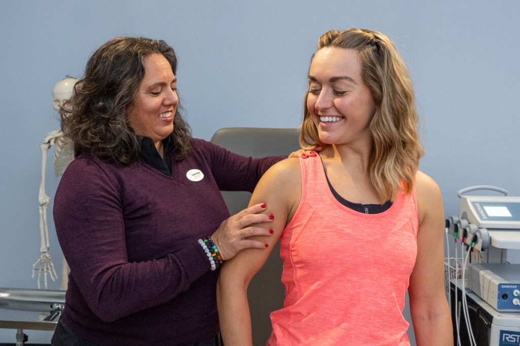 Balanced Flow clinician working on a patient's neck and shoulder to reduce neck pain naturally