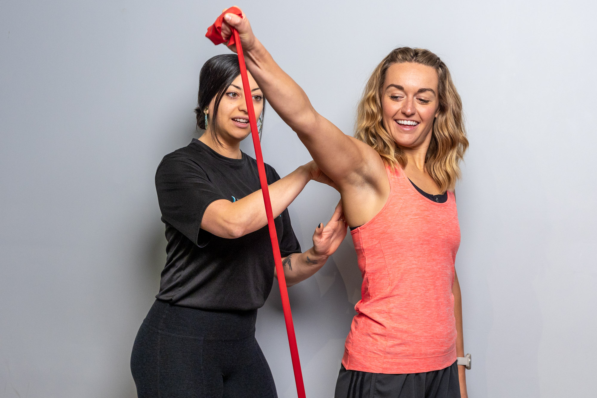 A female patient undergoes rehabilitation services near Wicker Park using a resistance band under the guidance of a Balanced Flow Wellness provider.