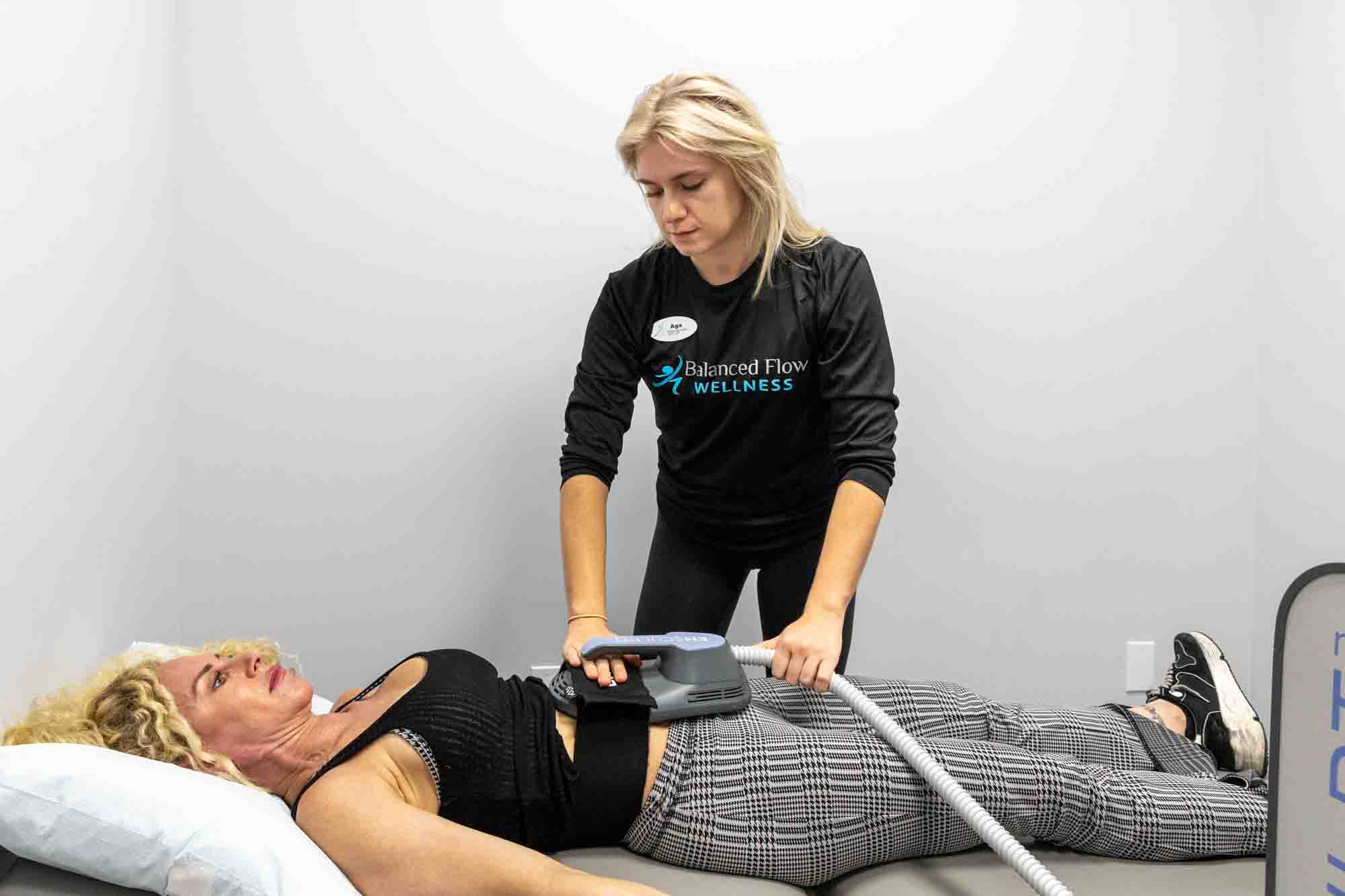 A woman lying down recievng an Emsculpt NEO treatment for Body Contouring in Chicago