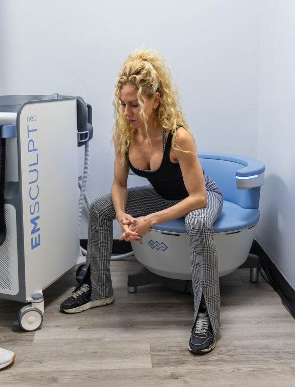A woman sitting on the Emsella chair to strengthen her pelvic floor and improve her urinary incontinence