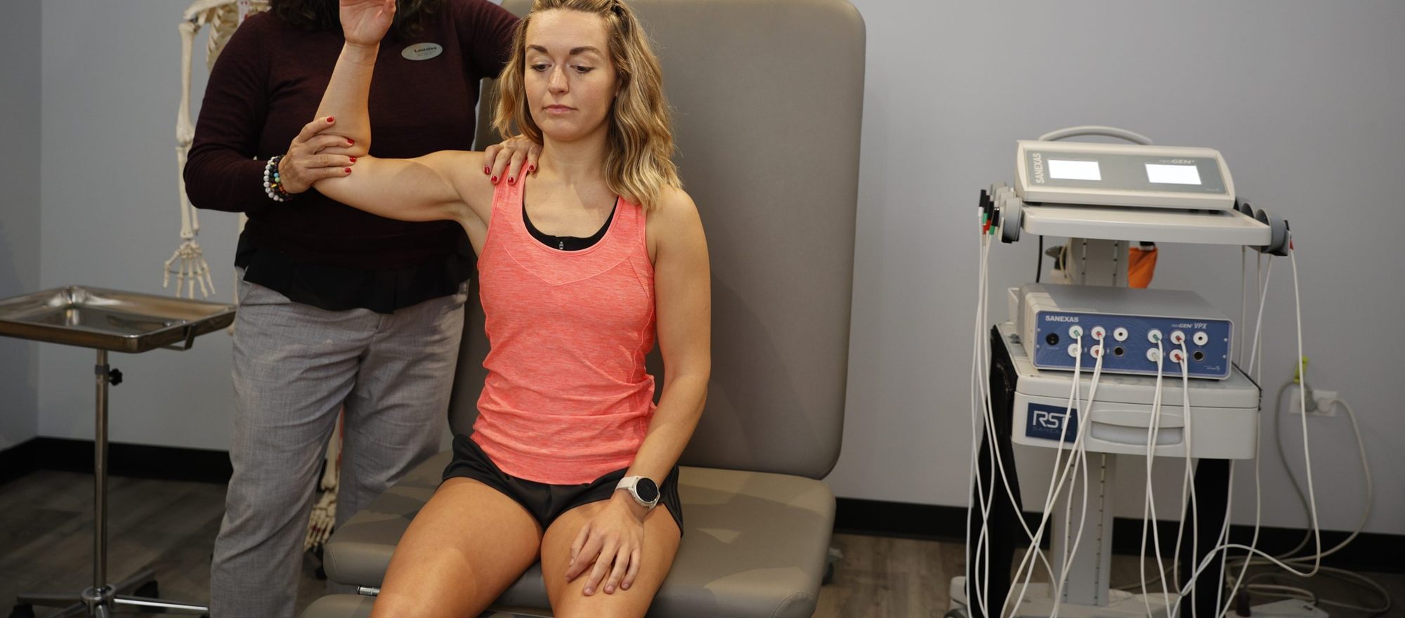 Physician assessing a patient's shoulder mobility during a functional evaluation in Chicago